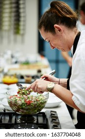 Lifestyle Photography Of A Cooking Class Taking Place At Williams Sonoma Cooking School Sydney Australia, A Caucasian Female Chef Tossing A Salad