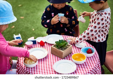 Lifestyle Photography Of Preschool Age Children Playing In Pretend Tea Time Scene In A Childcare Center