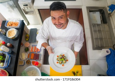 Lifestyle Portrait Of Asian Home Cook Man Or Professional Chef Cooking In Clean Kitchen Showing Traditional Japanese Sushi Roll Dish Happy And Proud In Japan Food Culture