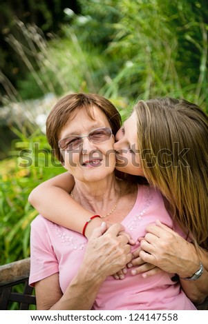 Similar – Woman taking selfie with older mother in wheelchair