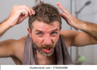 Lifestyle Portrait Of Mid Adult Attractive Concerned And Upset Man At Home Bathroom Searching And Finding Gray Hair Looking At The Mirror Worried About Aging 