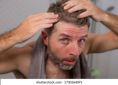 Lifestyle Portrait Of Mid Adult Attractive Concerned And Upset Man At Home Bathroom Searching And Finding Gray Hair Looking At The Mirror Worried About Aging 