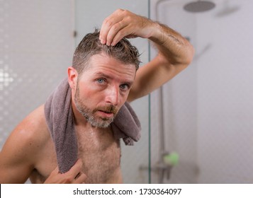 Lifestyle Portrait Of Mid Adult Attractive Concerned And Upset Man At Home Bathroom Searching And Finding Gray Hair Looking At The Mirror Worried About Aging 