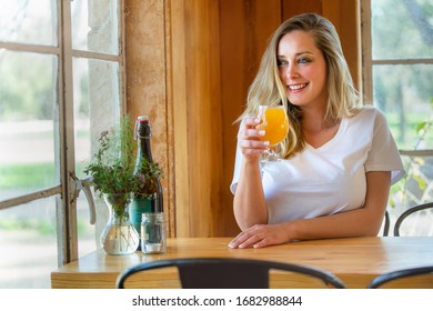 Lifestyle Portrait Of A Person Drinking A Pint Of Wheat Beer, Hefeweizen, IPA, Hazy NEIPA, At A Craft Brewery 