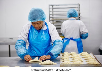 Lifestyle Reportage Photography Of A Pie And Pastry Wholesale Bakery Factory Workers Making Croissants By Hand