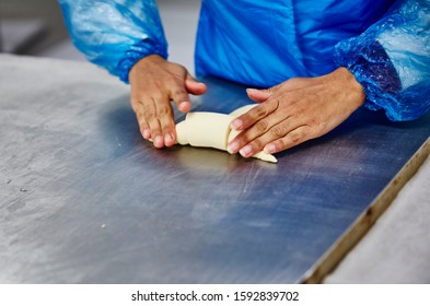 Lifestyle Reportage Photography Of A Pie And Pastry Wholesale Bakery Factory Worker Making Croissants By Hand