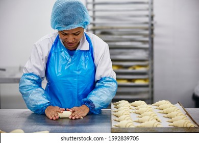 Lifestyle Reportage Photography Of A Pie And Pastry Wholesale Bakery Factory Worker Making Croissants By Hand