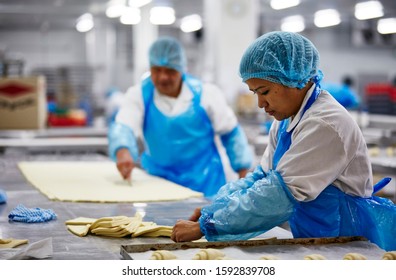 Lifestyle Reportage Photography Of A Pie And Pastry Wholesale Bakery Factory Workers Making Croissants By Hand