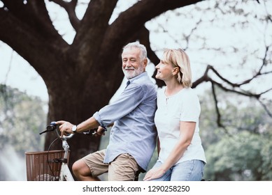 Lifestyle senior couple happy and relaxed . Good Healthy elderly in park nature. Group of Senior Retirement dancing and enjoy vacation summer  - Powered by Shutterstock