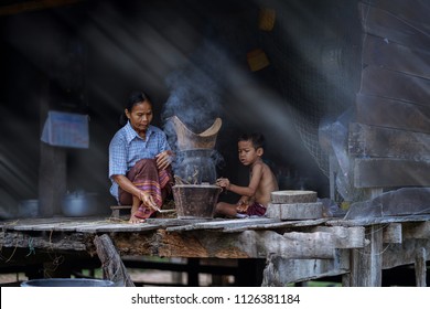 Lifestyle Of Southeast Asian People,mom And Son In The Home,countryside Thailand, Mom And Kid Cooking In Rural House,Southeast Asia          