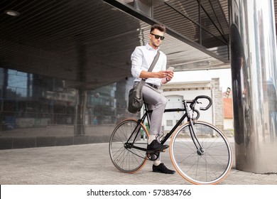 lifestyle, transport, communication and people concept - young man with bicycle and smartphone on city street - Powered by Shutterstock