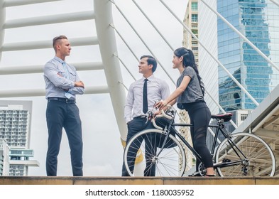 Lifestyle Two Business Man And Sport Woman  With Bicycle And Talking Is Happy  In City Background, Health Riding Bike