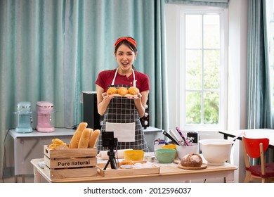 Lifestyle Young asians woman chef wearing apron and baking in home kitchen. Hobby lifestyles concept - Powered by Shutterstock