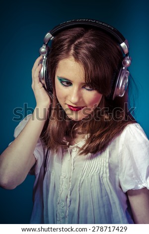 Similar – Young blonde woman listening to music with her headphones