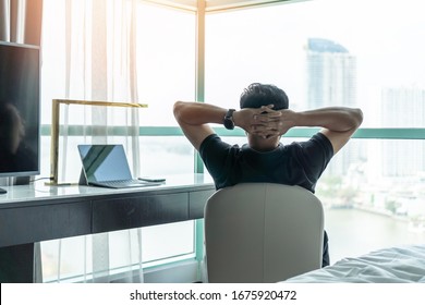 Life-work balance and city living life style concept of business man relaxing, take it easy in office room resting with thoughtful mind thinking of lifestyle quality looking forward to cityscape 