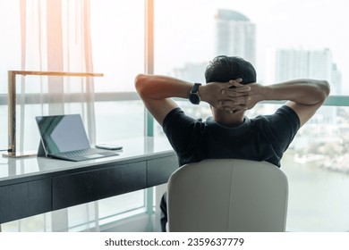 Life-work balance and living life style concept of businessman relaxing, take it easy in hotel or office room resting with thoughtful mind thinking of lifestyle quality looking forward to city - Powered by Shutterstock