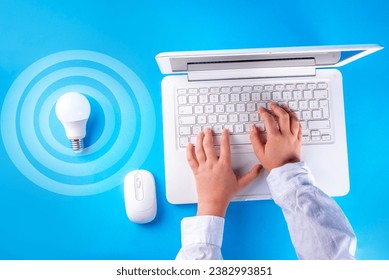 Li-Fi fast internet wireless connection concept, new lightening device, LED lamps energy-efficient data transmission communication technology. Unrecognizable person use smartphone tablet with Li-Fi