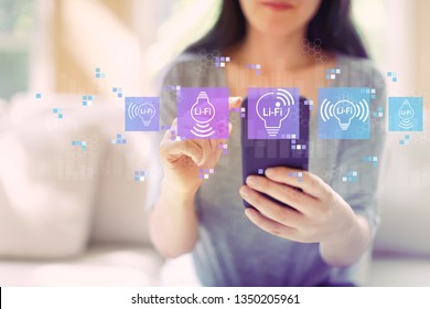 LiFi theme with woman using her smartphone in a living room