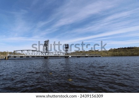 Lift bridge connecting Minnesota and Wisconsin on the St Croix River.  Barge traffic is a regularity, as is fishing for bass and boating on the scenic byways. 