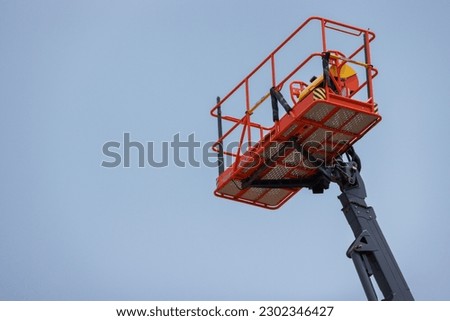 Lift buckets machine against the blue sky. Mobile construction crane for rent and sale. Aerial work platforms of a cherry picker.