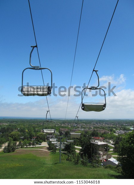 Lift gondolas in Ontario\
Canada in summer going up a hill on elevator escalator transport\
skiing
