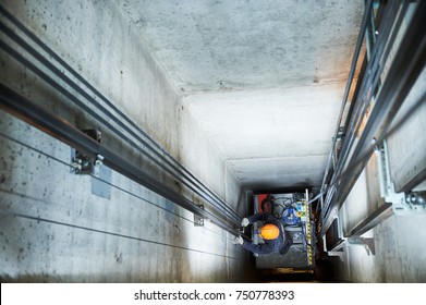 lift machinist repairing elevator in lift shaft