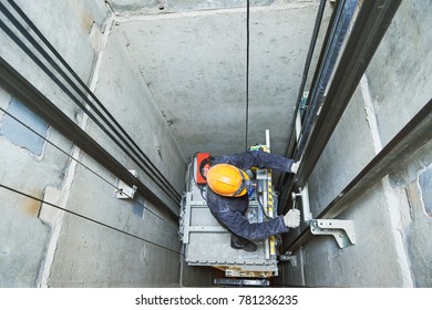 Lift Machinist Repairing Elevator In Lift Shaft