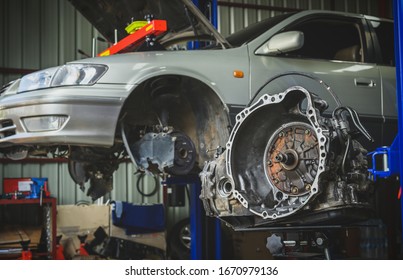 Lifting The Automatic Transmission To Repair And Overhaul In The Car Garage Shop.