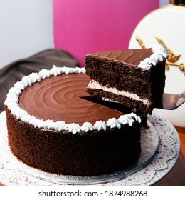 Lifting Up Chocolate Cake Slice. 2 Pound Chocolate Cake On Cake Stand