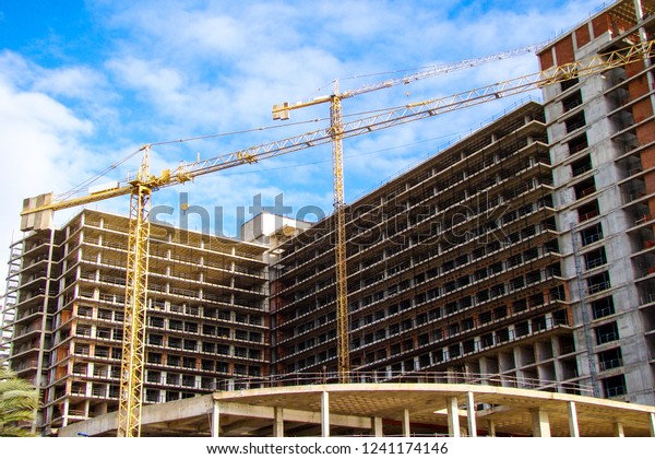 Lifting\
crane Building. Construction site. City building. City\
architecture.                              \
