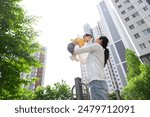  Mother lifting her baby during a walk in an apartment complex in Korea