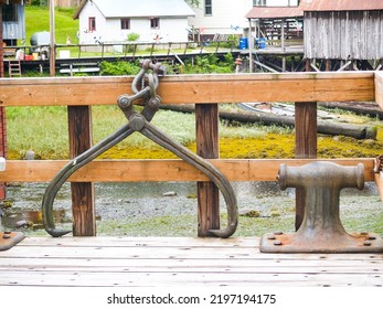 Lifting Hook Or Caliper On Shackle Over Railing And Iron Bollard On Pier In Petersburg, Alaska.