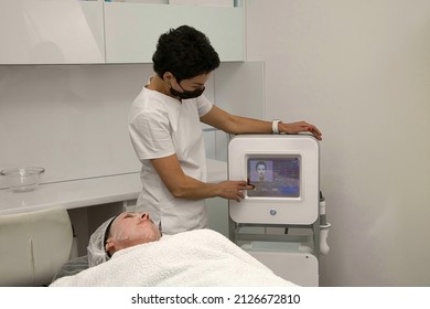 Lifting The Skin Of The Face In A Beauty Salon With Electric Radio Waves, The Patient Is Over Forty Years Old Lying On The Couch.