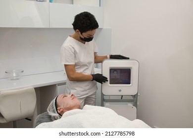 Lifting The Skin Of The Face In A Beauty Salon With Electric Radio Waves, The Patient Is Over Forty Years Old Lying On The Couch.