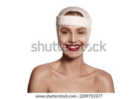 Lifting, therapy concept. Female face bandaged with medical bandages and human emotions concepts. Making beauty, modifying face to make surgical correction, plastic surgery. correction of asymmetry.