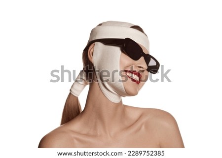 Lifting, therapy. Female face bandaged with medical bandages and sunglasses with human emotions. Making beauty, modifying face to make surgical correction, plastic surgery. correction of asymmetry.