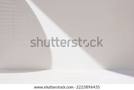 Light ackground image in gray tones with minimalist design of lights and shadows for product presentation or other creative purposes.