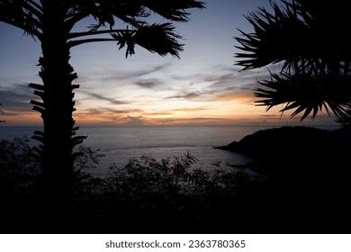 The light after sunset has both orange and yellow colors at Laem Phromthep. Phuket Province, Thailand
