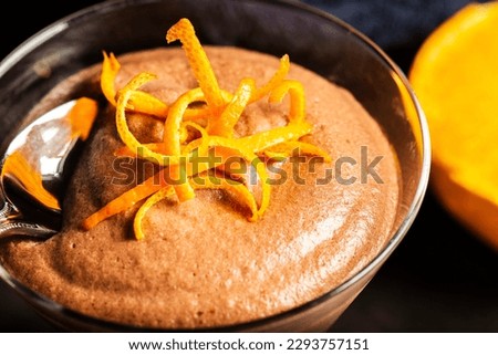 Light and airy orange chocolate mousse with decorative orange strands.