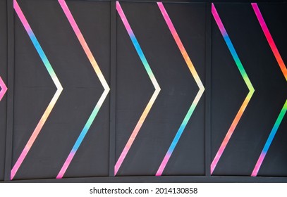 Light Arrow Indicating Direction In Multicolor Fluorescent Painting Abstract Background.