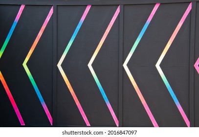 Light Arrow Indicating Direction In Multicolor Fluorescent Painting Abstract Background.