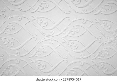 Light background of decorative plaster with abstract spots. Unusual texture of white or gray wall with beautiful patterns, creative surface background. Finishing coating for building cladding.