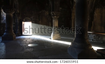Light beam falling into an empty dark room of Geghard Monastery in Armenia, Eastern Europe.