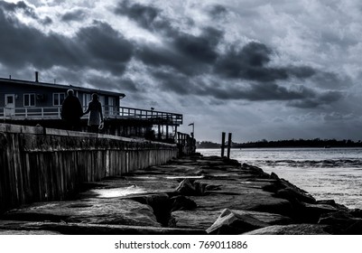Light beams passing through the clouds over the pier monochrome background. Barnegat Lighthouse State Park, NJ