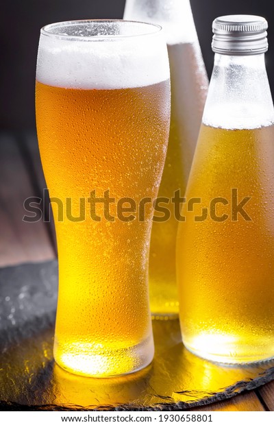Light beer in a\
glass, on an old\
background.