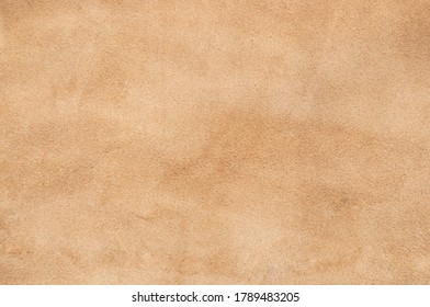 Light Beige Matte Background Of Suede Fabric, Closeup. Velvet Texture Of Seamless Sand Leather