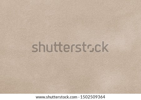 Light beige matte background of suede fabric, closeup. Velvet texture of seamless sand leather. Imagine de stoc © 