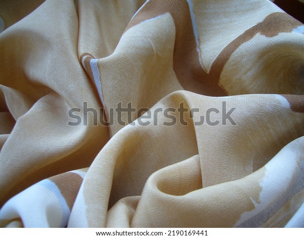 Light beige silk, crepe de chine. The\
texture of the fabric. Beige textile\
background.