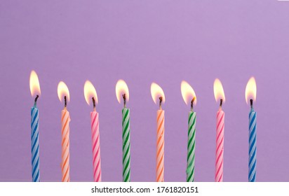 Light A Birthday Candles On Purple Background, Happy Birthday