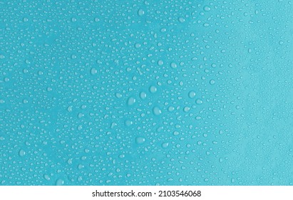 Light blue background with large and small drops of water in natural light. The texture of a water drop on a colored background is a top view. - Powered by Shutterstock